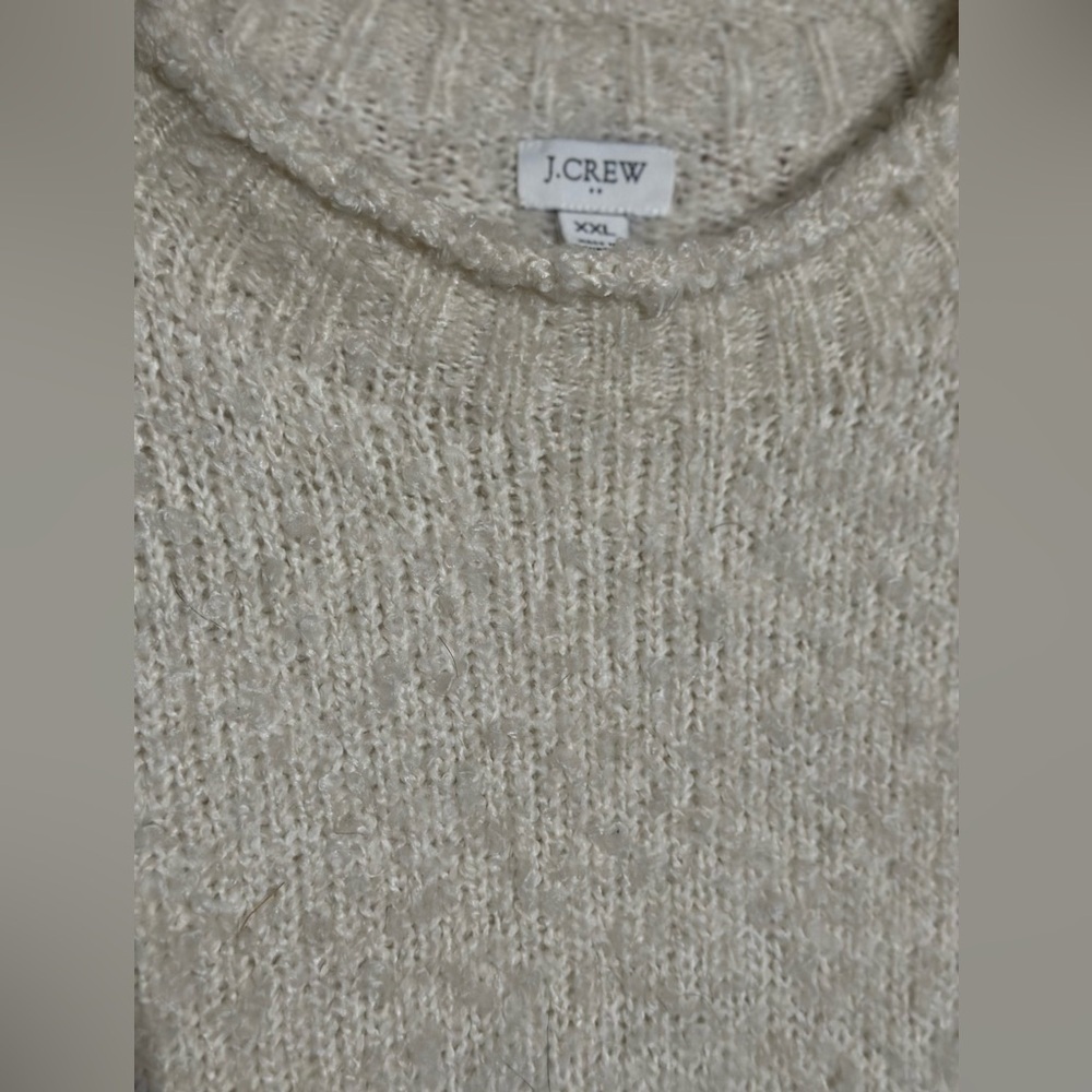 This is a J.Crew alpaca-blend sweater in a light color.